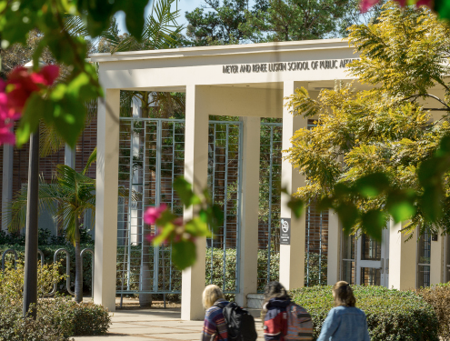 Students walking by the entrance to the Luskin School of Public Affairs