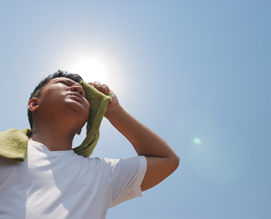 Person wiping forehead, hot in the sun