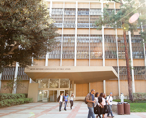 Students walking in front of the UCLA Luskin School of Public Affairs