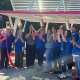 Collaborators celebrate the unveiling of a new bus shelter in Oasis, California