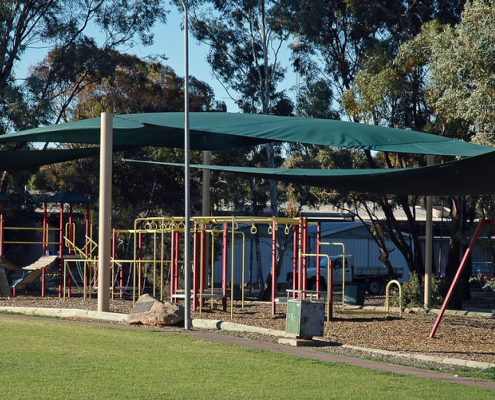 Play structure at school shaded by shade sails overhead