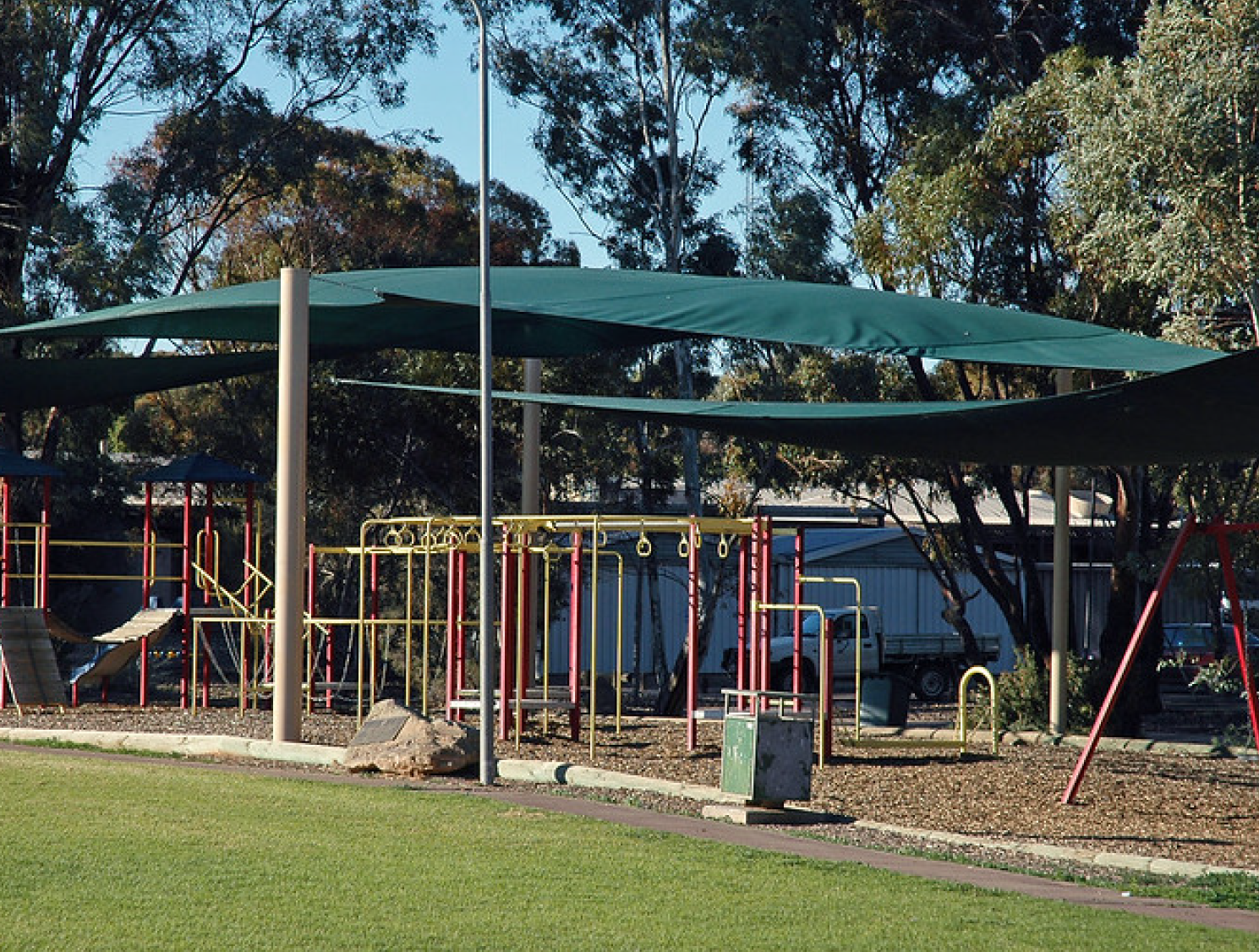 Play structure at school shaded by shade sails overhead