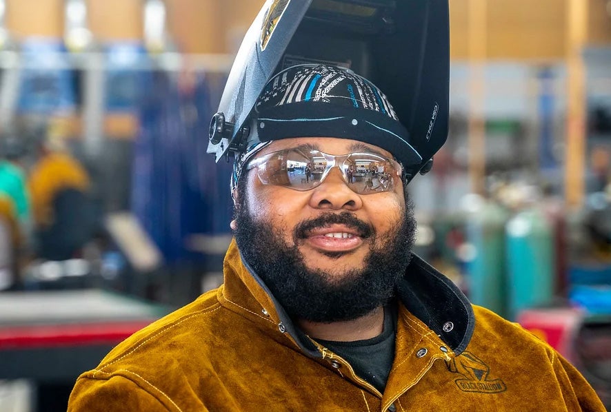 Aaron Greenwood in welding gear.