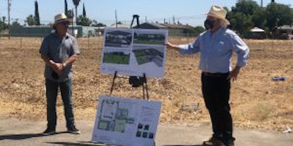 Keith Bergthold (right) presents visuals of the new building, to be constructed adjacent to the Food Hub.