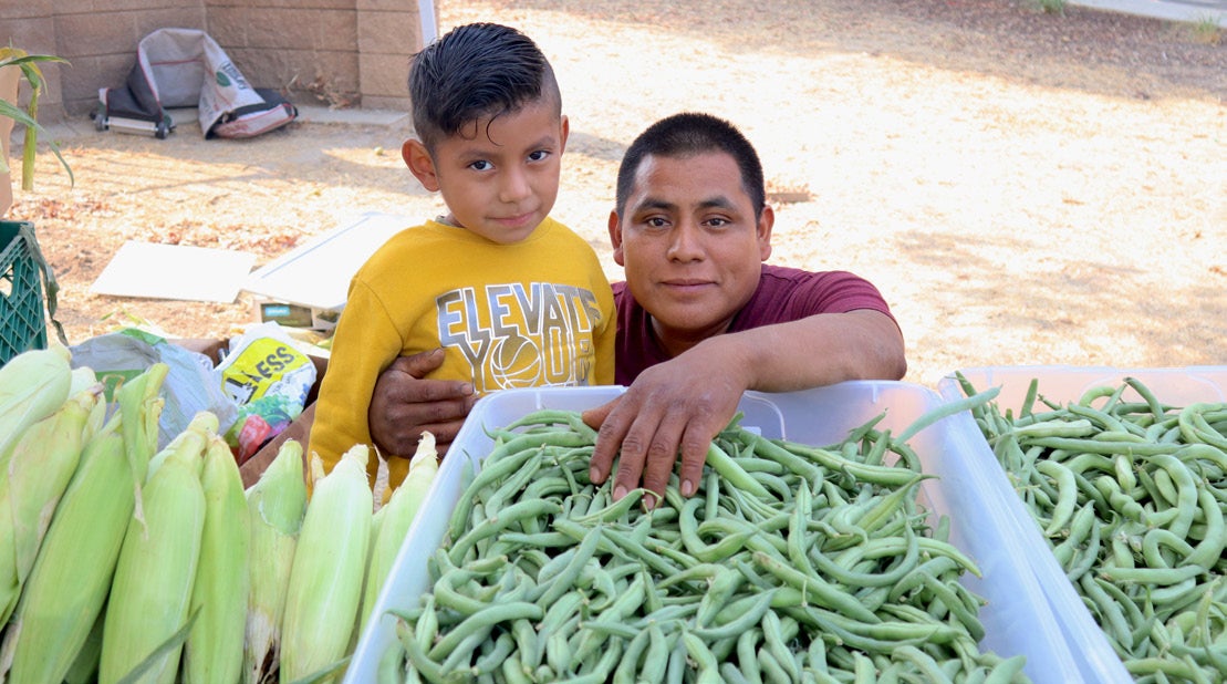 Miguel Avendaño and son at the Yo’Ville Farm Stand.