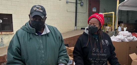 Ron Wiley and Bernice Wiley distribute food outside the food hub warehouse.