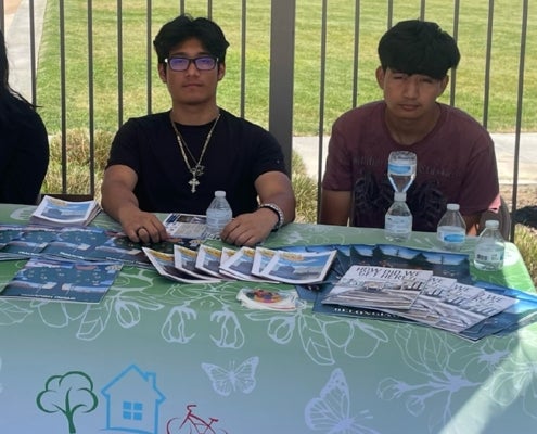Christopher (right) and Delilah (center) plant herbs with other Youth Leadership Development Program participants.