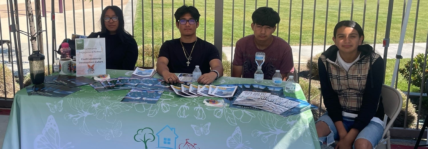 Youth Leadership Development Program participants Christopher (right) and Delilah (center) plant herbs with other Youth Leadership Development Program participants.